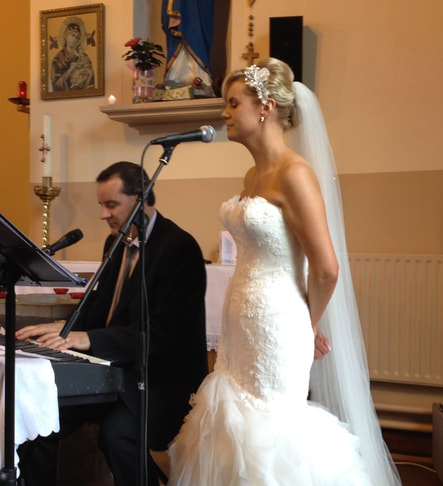 Galway wedding Singer and piano Player performs a song with bride at Abbeyknockmoy Church.